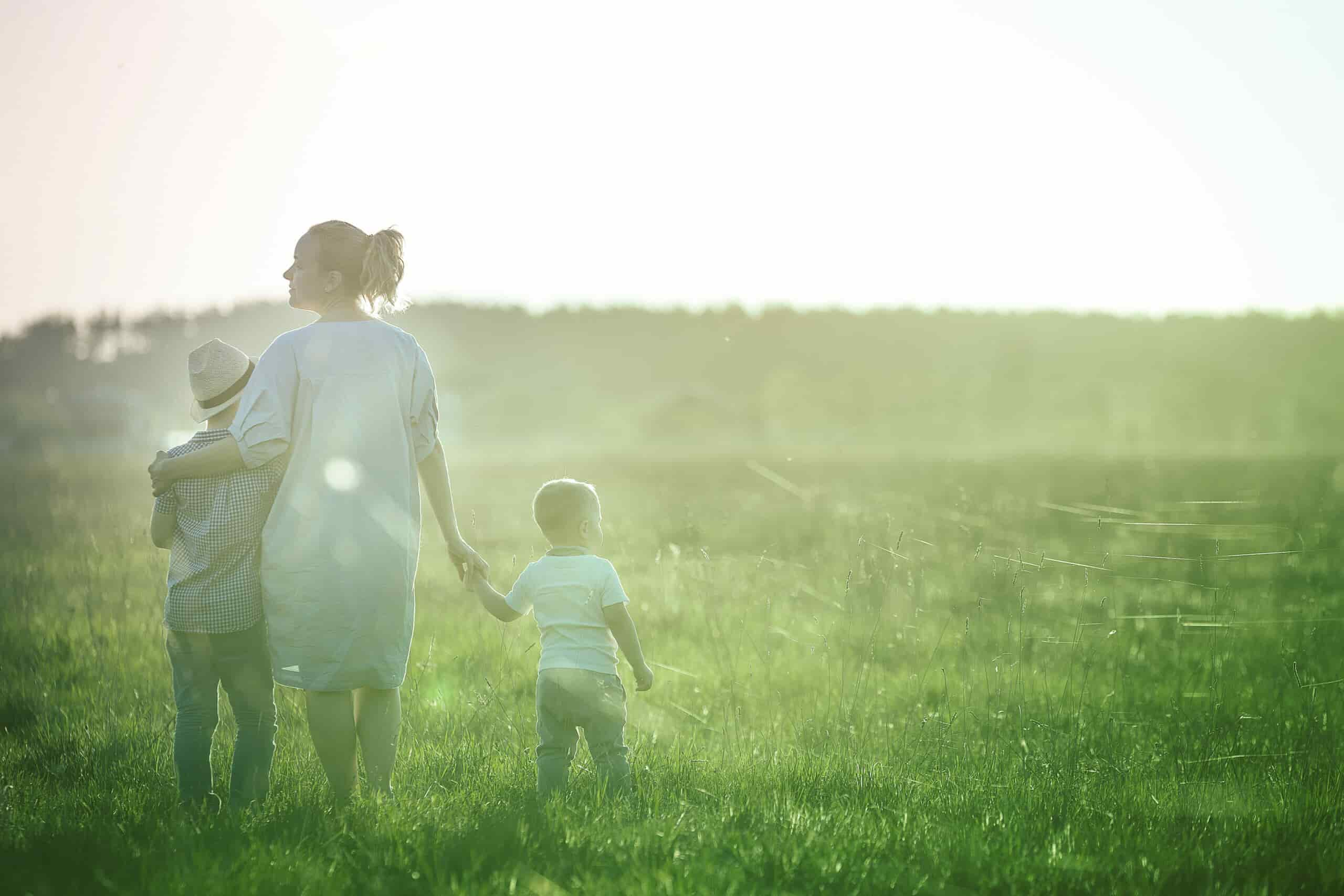 Mom and her two sons looking at a field